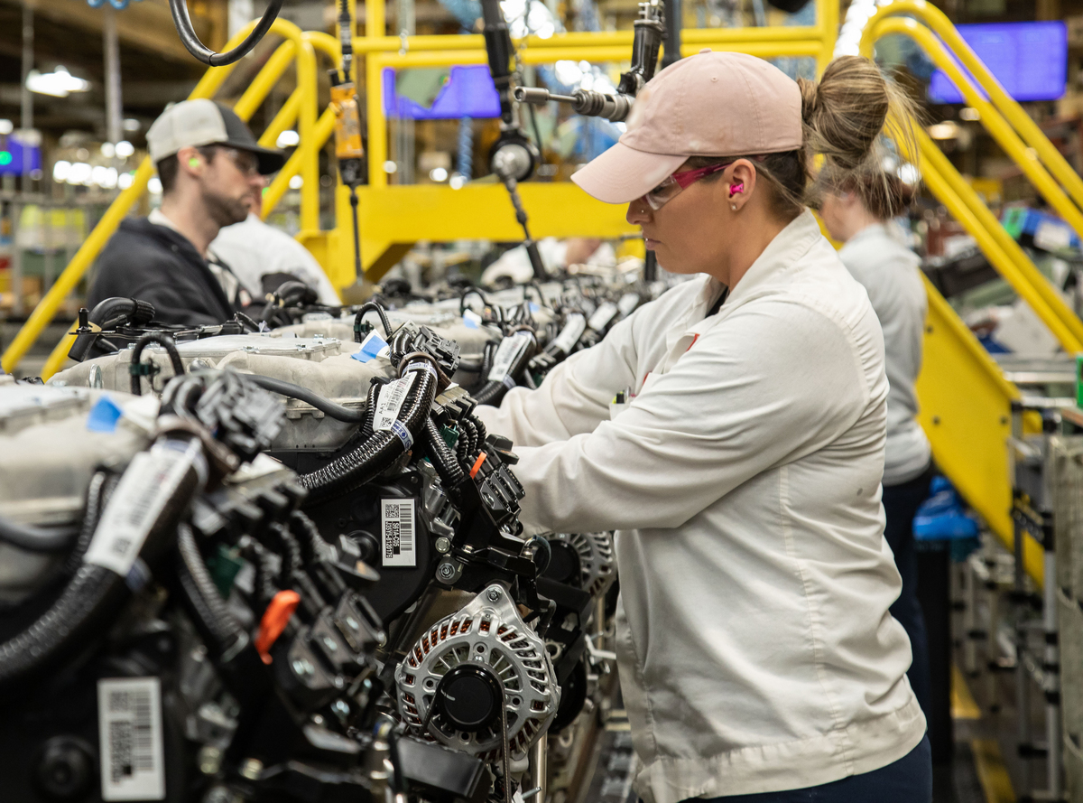 a technician assembles an internal combustion engine