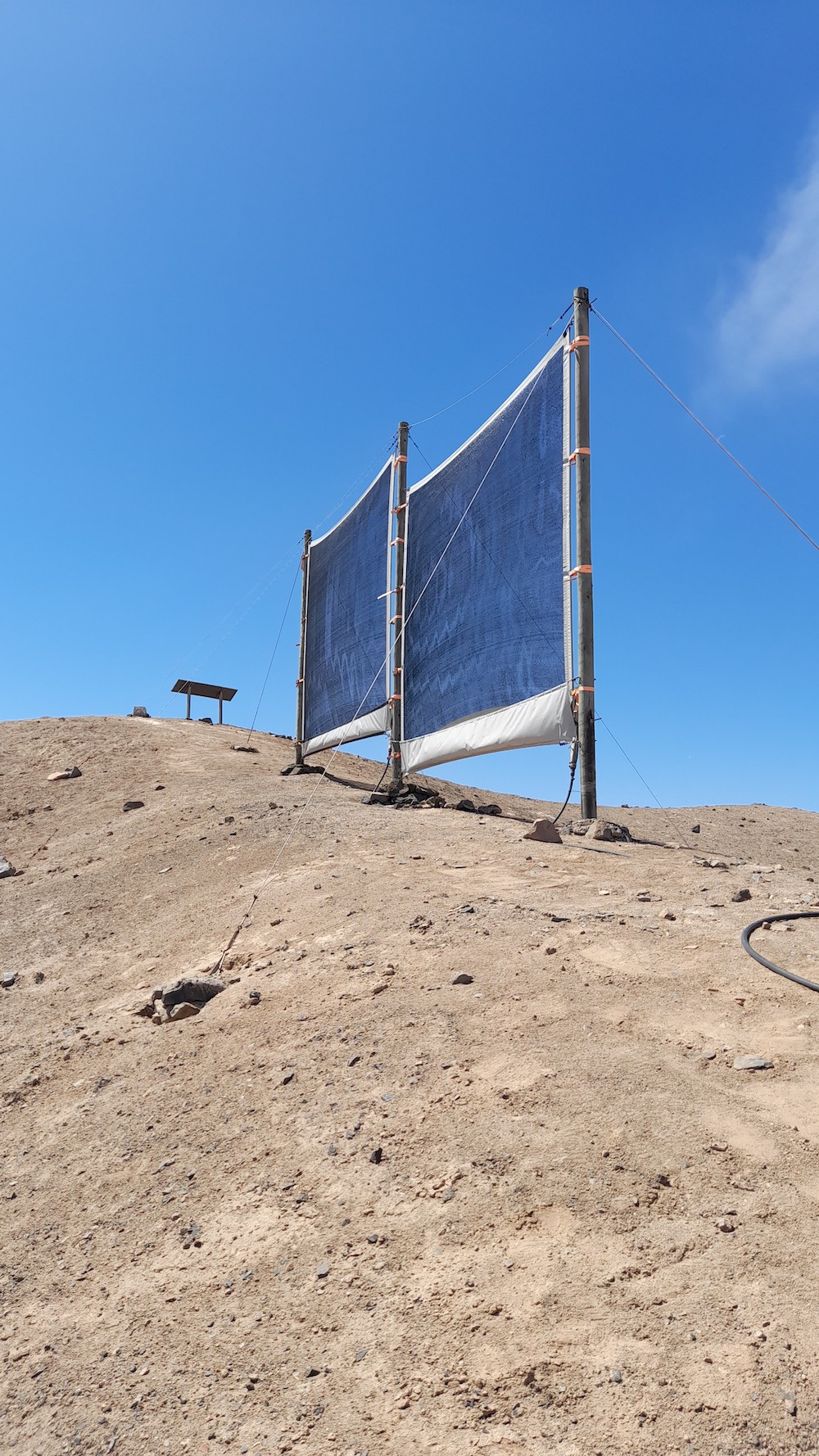 two mesh panels on a dusty hillside 