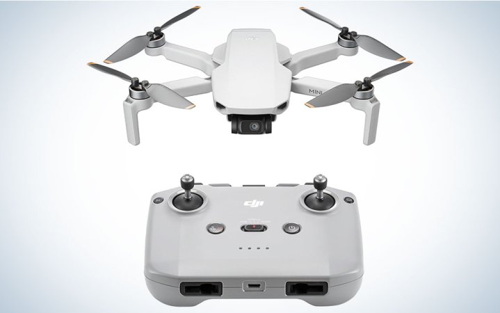  DJI Mini 4K with its controller on a plain background